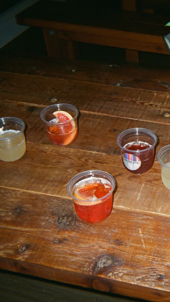 Seven spritzes left on a long wooden table