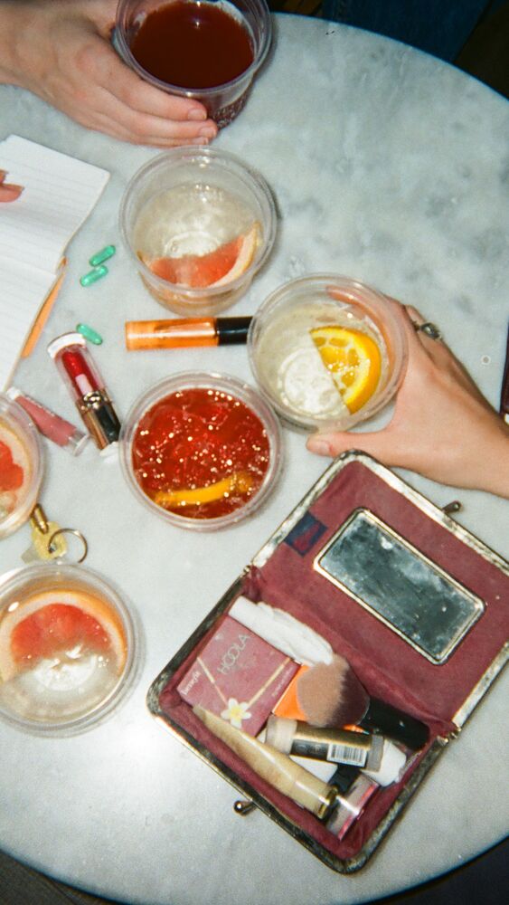 Spritzes with grapefruit and orange on a round marble table, seen from above